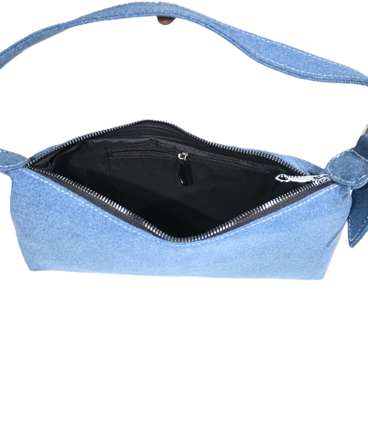 Open blue denim handbag showing spacious black interior with zip pocket and shoulder strap