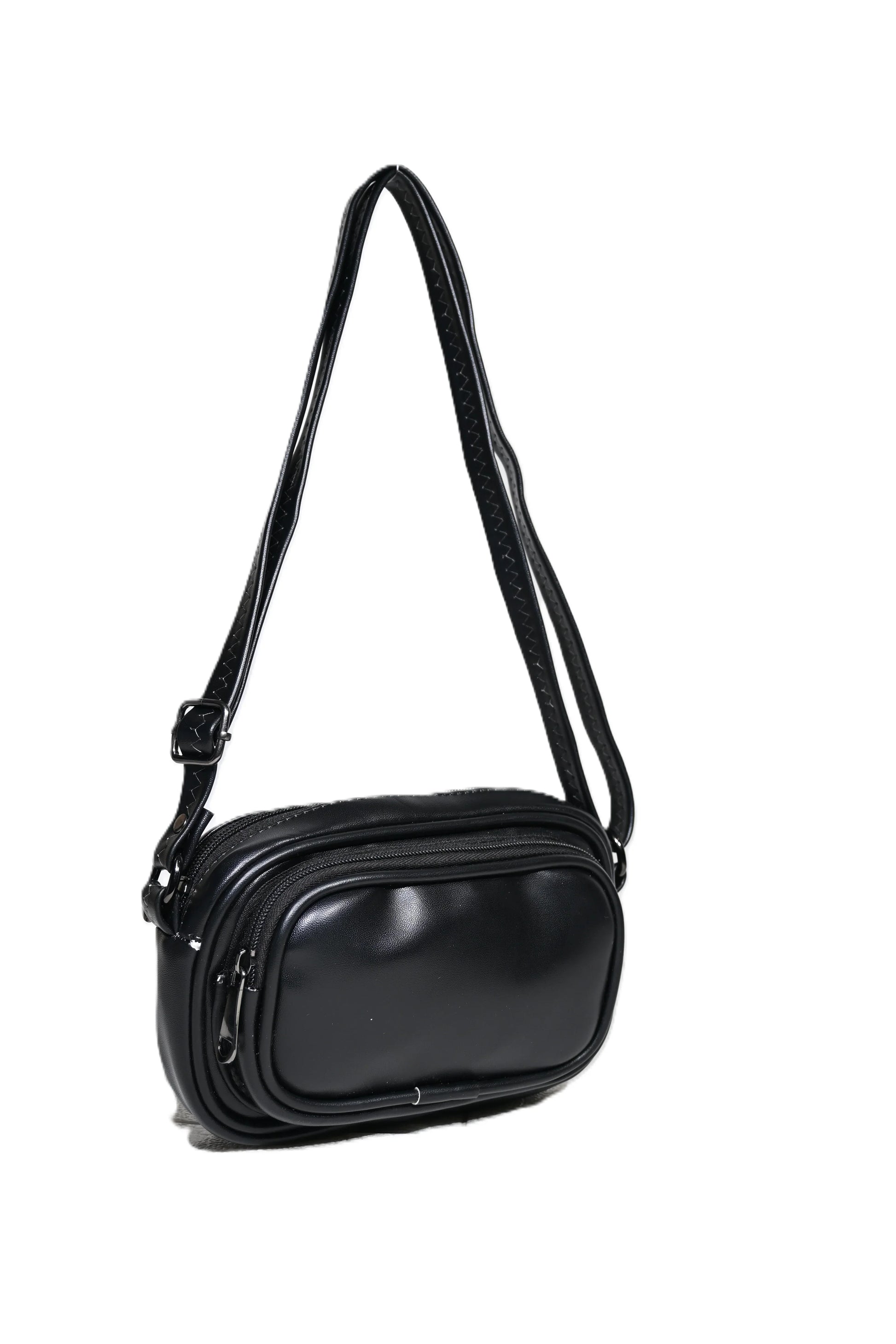 Black leather crossbody handbag with zipper pockets and adjustable strap on white background