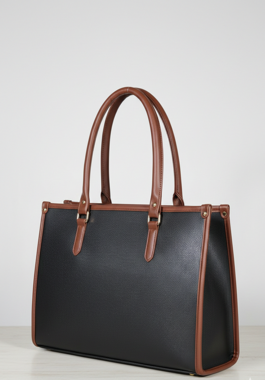 Black leather handbag with brown handles and trim on a neutral background