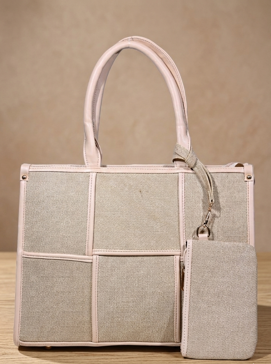 Beige woven handbag with double handles and matching zip pouch on neutral background